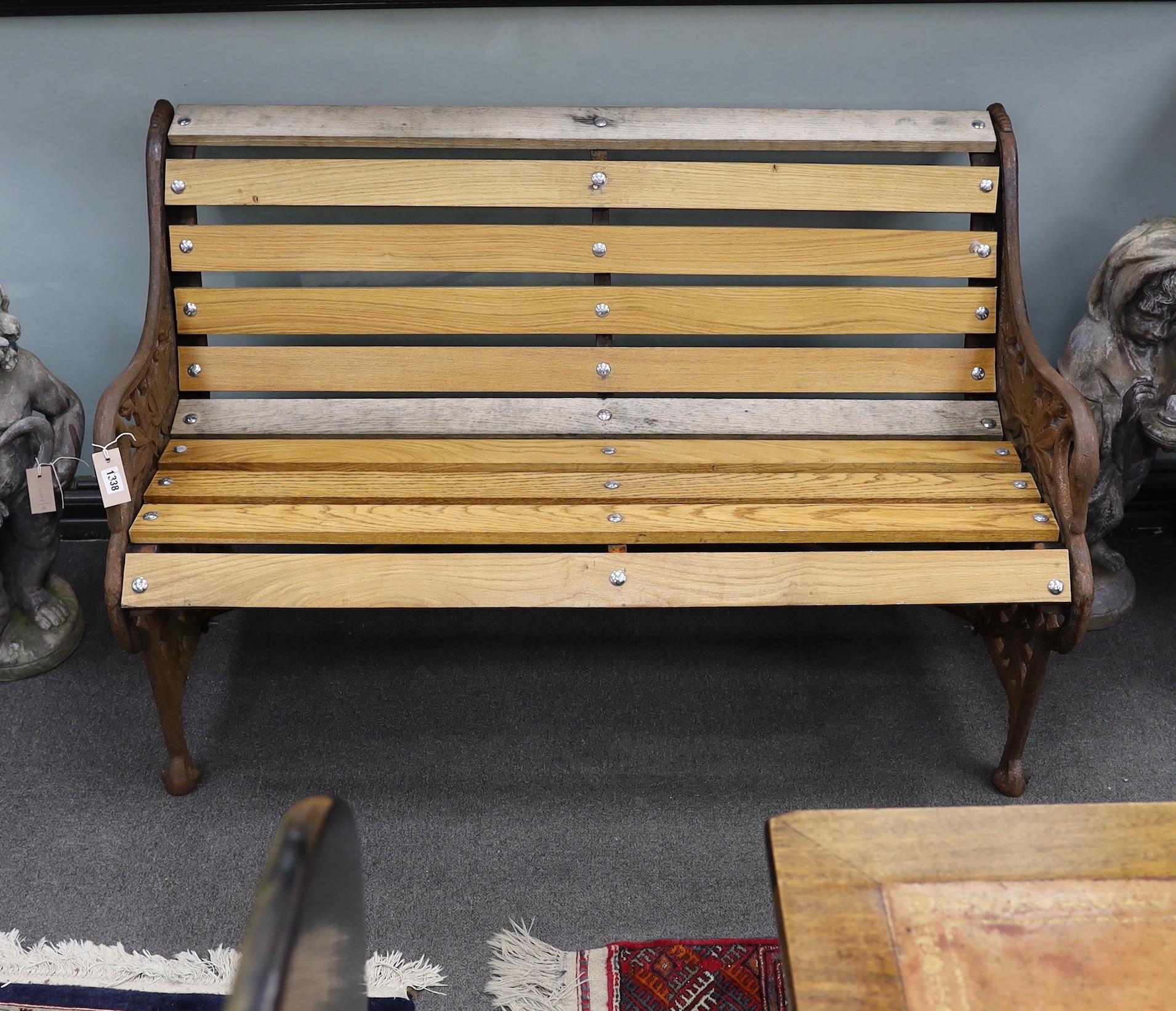 A Victorian Coalbrookdale passion flower pattern cast iron garden bench restored with later ash slats, length 129cm, depth 64cm, height 82cm